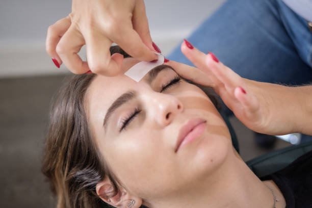 An Armenian woman gets her eyebrows done at a beauty salon